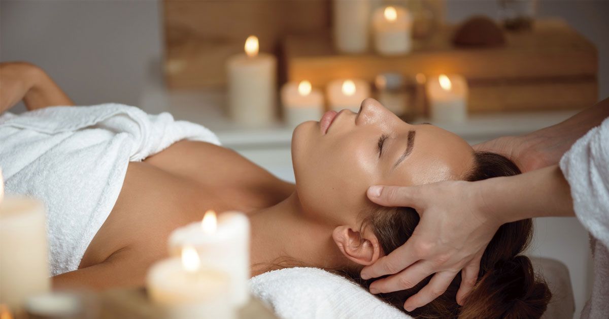 Woman receiving head massage